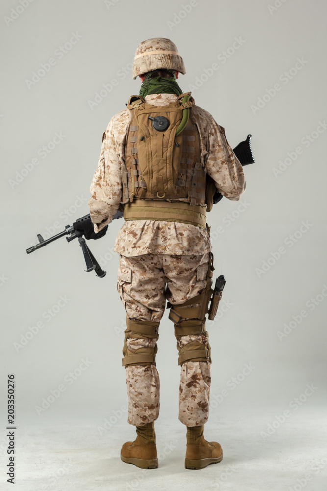 Soldier in camouflage holding rifle Soldier in camouflage holding rifle
