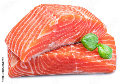 Fresh raw salmon fillets  decorated with green basil.