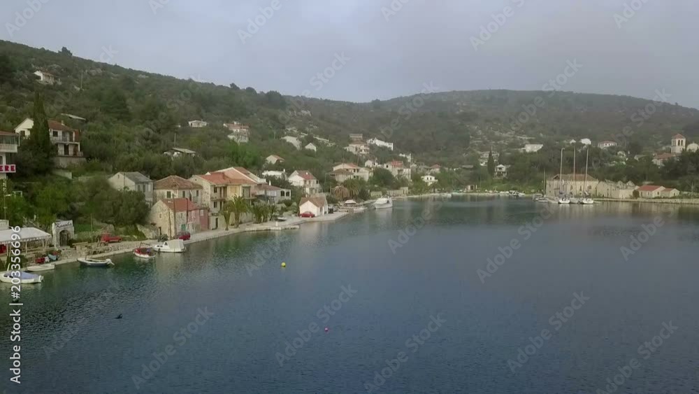Aerial: Drone going up in front of city. Lots of ancient old traditional fishing houses. Filmed on sailing trip in Adriatic sea in Croatia. Aerial: Drone going up in front of city. Lots of ancient old traditional fishing houses. Filmed on sailing trip in Adriatic sea in Croatia.