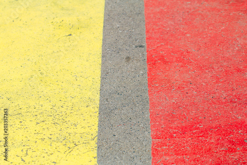 Yellow and red lines on a asphalt road.