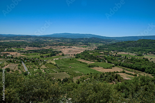 Panoramic view of the fields and hills of Provence near Gordes, under sunny blue sky. Located in the Vaucluse department, Provence region, in southeastern France