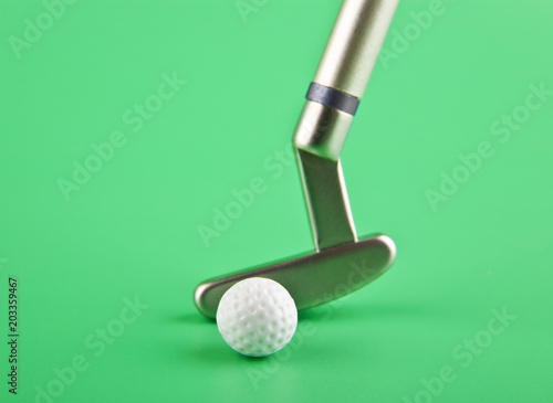 golf club with a ball on a green background