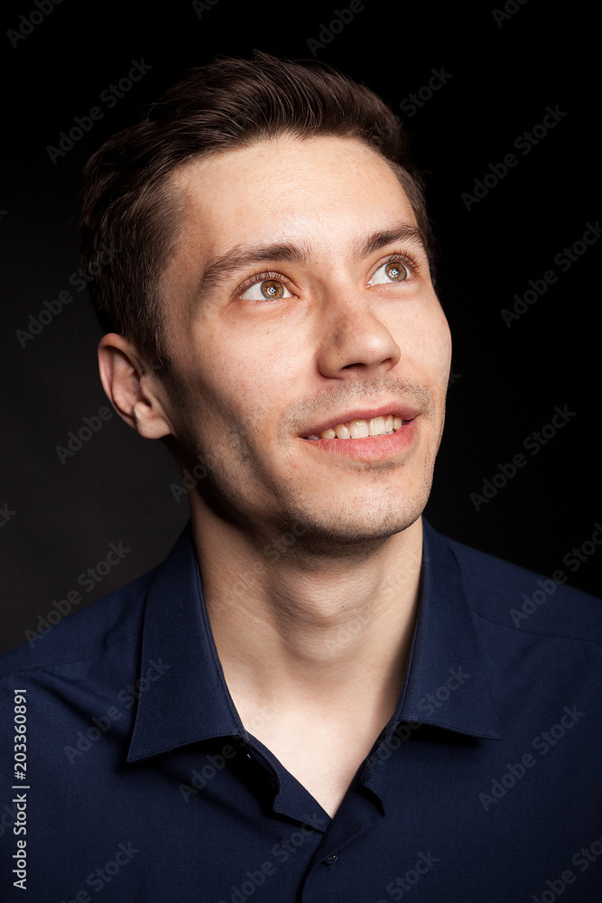 Obraz premium Fashion portrat of young man on black background in studio photo
