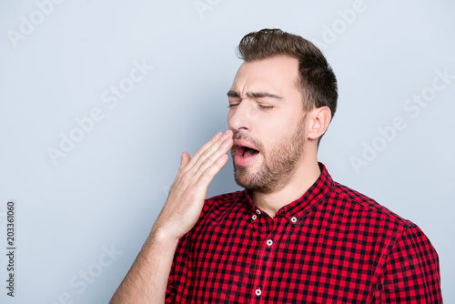 Portrait of sleepy tired passive clothed in casual red checkered shirt outfit he caugth a cold and wants to sneeze, isolated on gray background, copy-space photo