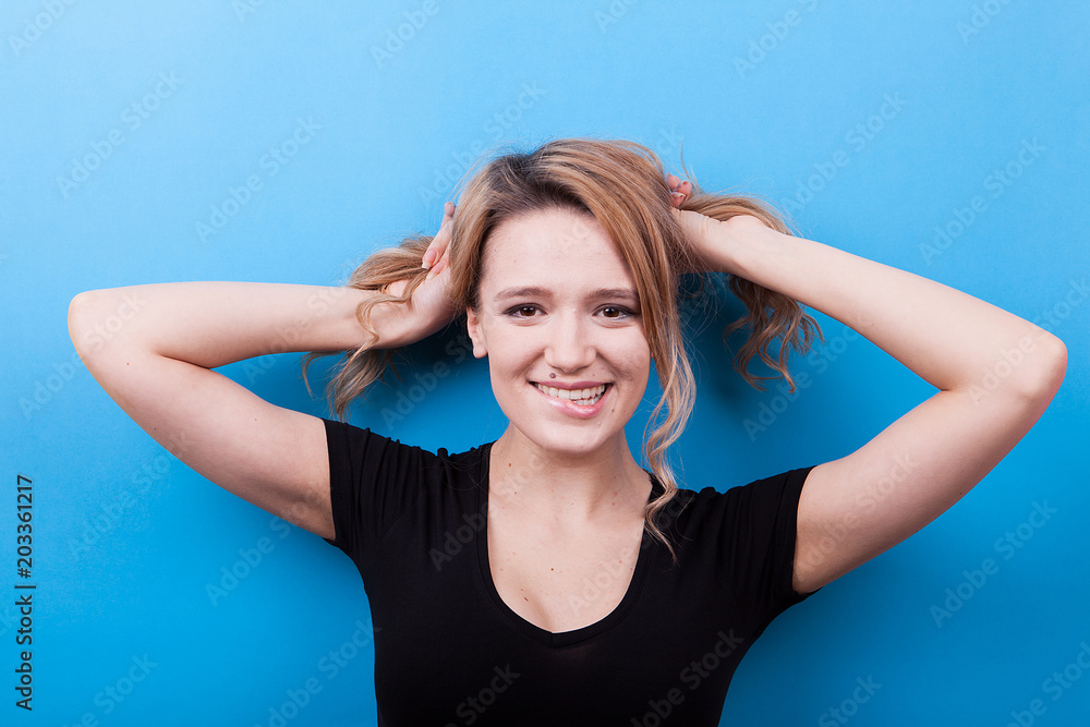 Portrait of young woman on blue background in studio photo Portrait of young woman on blue background in studio photo