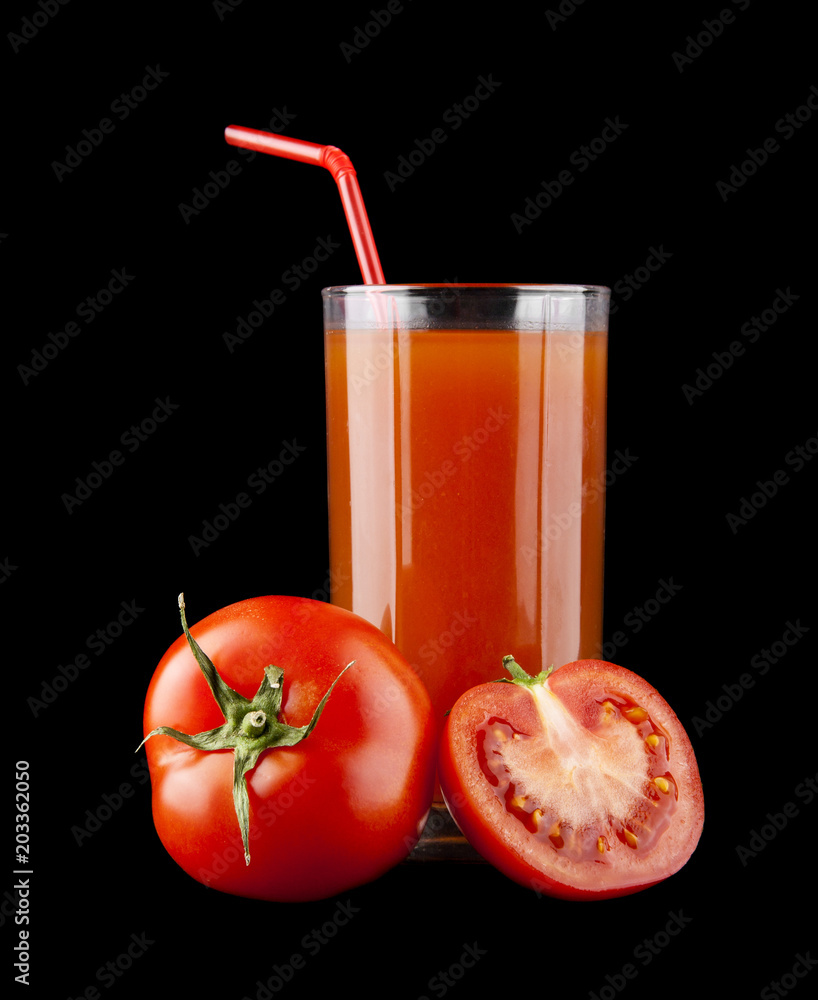 tomato juice in a glass and tomatoes on a black background tomato juice in a glass and tomatoes on a black background