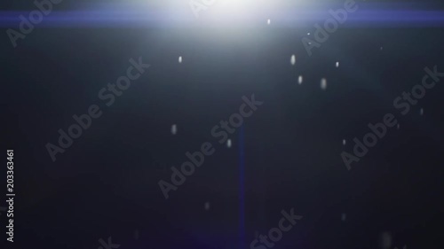 Defocused, Bokeh Particles Slowly Falling in the Light on the Black Background. Anamorphic Real Lens Flare that is Easy to Use in Blend / Overlay Modes. photo