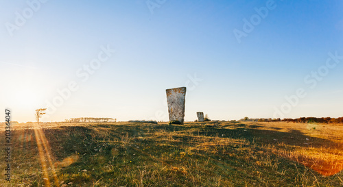 Menhir, Kungsstenen en rest sten på Ölands Södra udde Ottenby , gravlämning i solnedgång photo