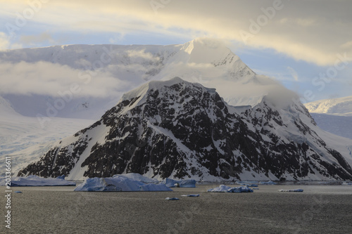 Sunrise, with atmospheric cloud and mist, mountains, glaciers and icebergs, Neko Harbour, Andvord Bay, Graham Land, Antarctica photo