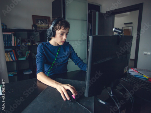 Teenager playing at computer game