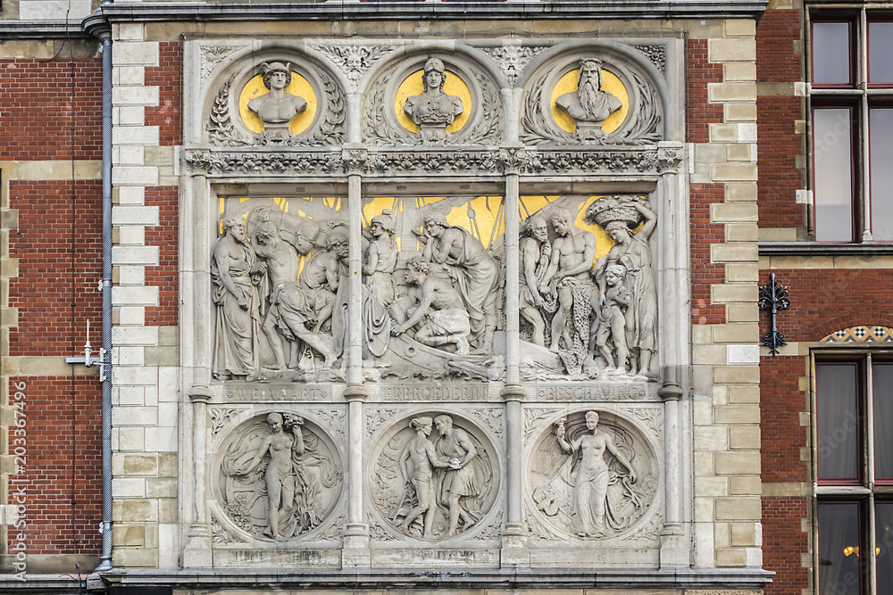 Fototapeta premium Architectural fragments of Historic building of Amsterdam central railway station (Amsterdam Centraal), Netherlands. Amsterdam Centraal's building first opened in 1889.