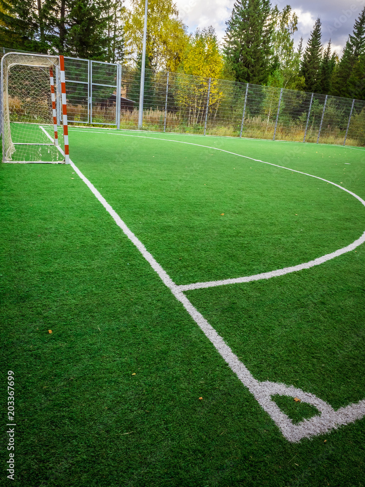 Corner of a soccer. Soccer field with green grass yard and football goal in school area. beautiful sport playground.