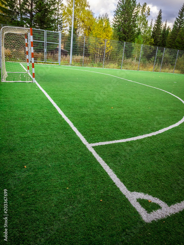 Corner of a soccer. Soccer field with green grass yard and football goal in school area. beautiful sport playground.