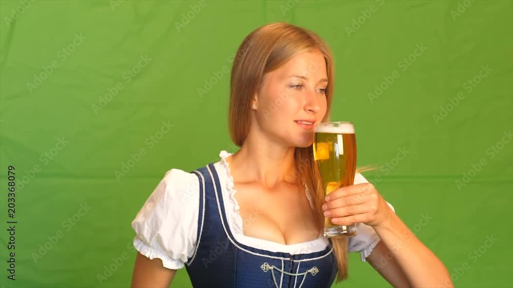 Woman in bavarian costume laughs and shows thumbs up. Green screen Woman in bavarian costume laughs and shows thumbs up. Green screen