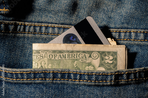 Credit cards and money in jeans pocket