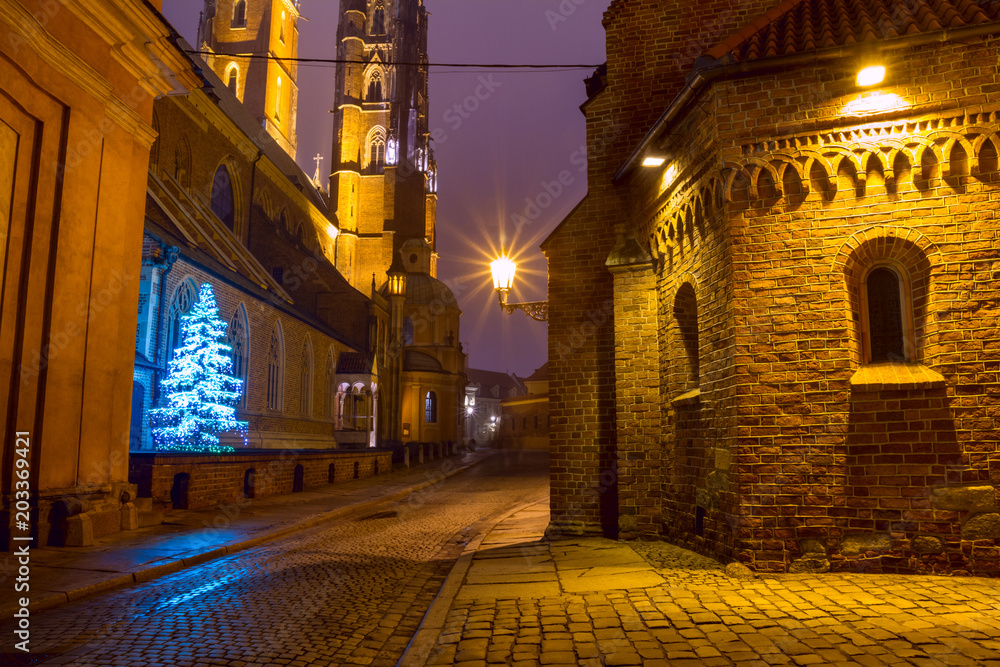Christmas cityscape - evening view of the Cathedral of St. John the Baptist, located in the Ostrow Tumski old district of the city of Wroclaw, in Lower Silesia Province, Poland