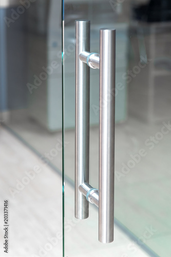 Photography The metal handle of the glass door in the interior of the room, close-up