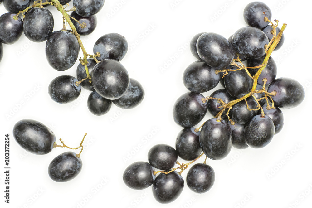 Black grape clusters (autumn royal variety) with two purple berries top view isolated on white background. Black grape clusters (autumn royal variety) with two purple berries top view isolated on white background.