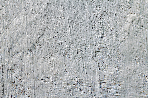 Grungy white concrete wall background. Wall with painted stucco