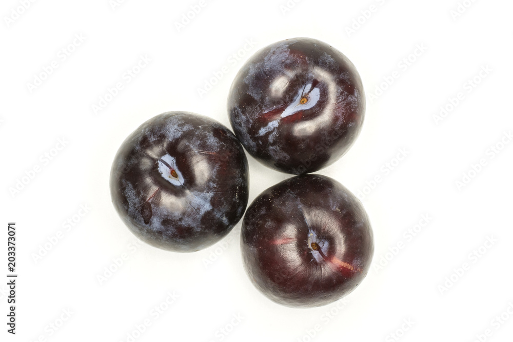 Three red blue plums top view isolated on white background round whole fresh juicy fruit. Three red blue plums top view isolated on white background round whole fresh juicy fruit.