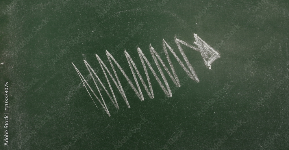 Arrow drawn on chalkboard, blackboard background, texture