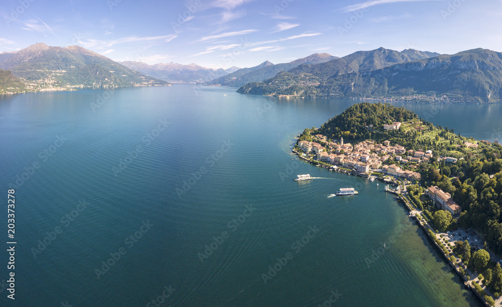Panoramic aerial view of Bellagio on green promontory surrounded by Lake Como, Province of Como, Lombardy, Italian Lakes (Drone) Panoramic aerial view of Bellagio on green promontory surrounded by Lake Como, Province of Como, Lombardy, Italian Lakes (Drone)