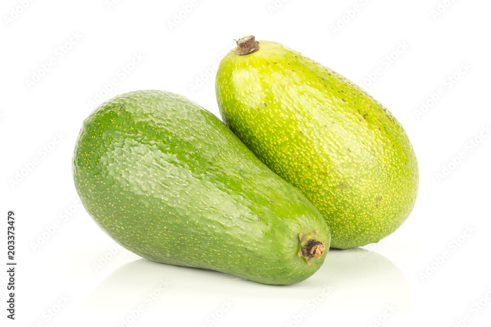 Two green smooth avocado isolated on white background ripe bacon variety. Two green smooth avocado isolated on white background ripe bacon variety.