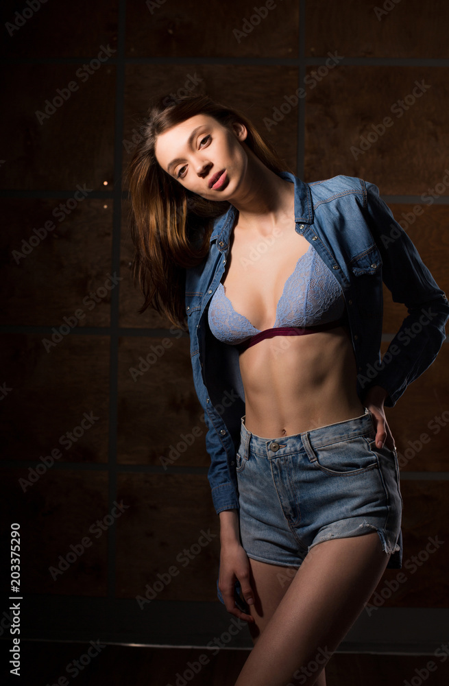 Test photo shoot for young attractive model wearing jeans shirt and lace bra  Stock Photo
