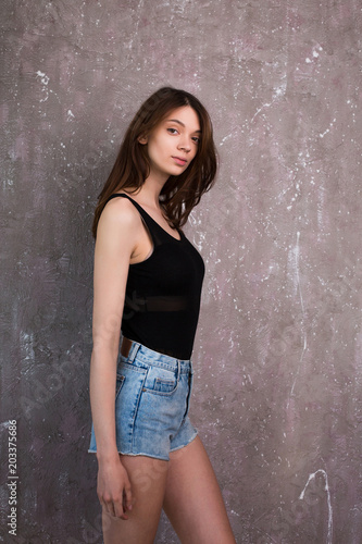Test photo shoot for young pretty woman wearing jeans shorts and black shirt