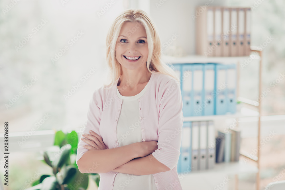 Nice accountant, cute director, friendly, aged headmistress having her arms crossed, standing in workstation Nice accountant, cute director, friendly, aged headmistress having her arms crossed, standing in workstation