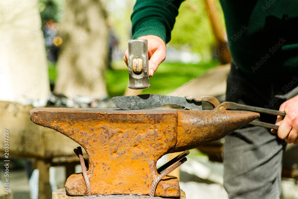 blacksmith with an anvil and a hammer on the street blacksmith with an anvil and a hammer on the street