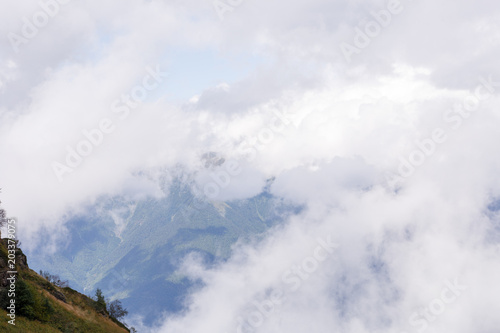 Photo of mountain slopes with cloudy sky © nuclear_lily