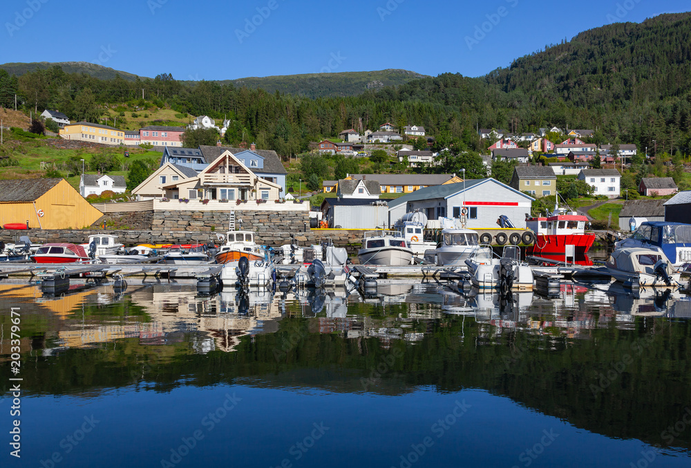 Traditional norwegian fjord village with small harbor, Hardanger fjord in the municipality of Odda, Norway