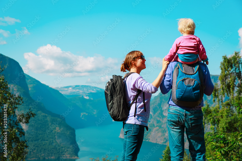 happy young family with small baby travel in Norway