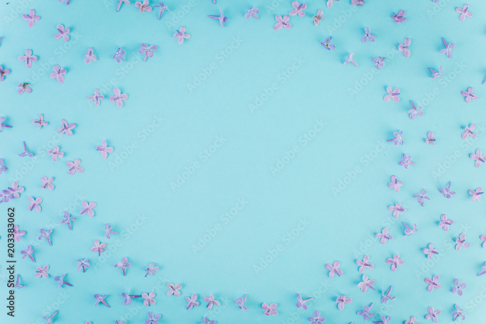 Petals of violet lilac on a blue background.