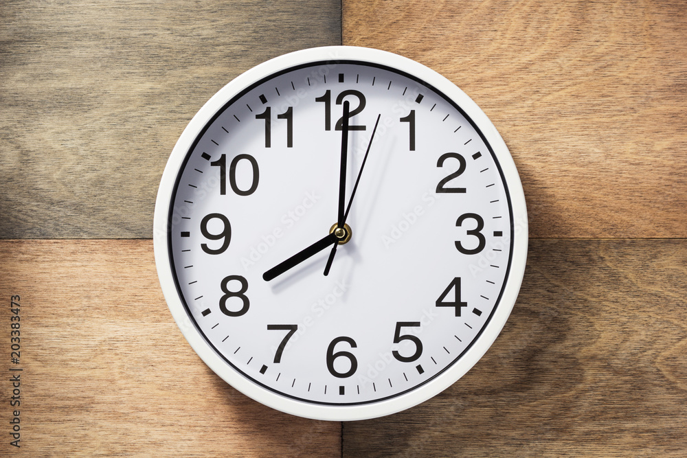 wall clock at wooden background wall clock at wooden background