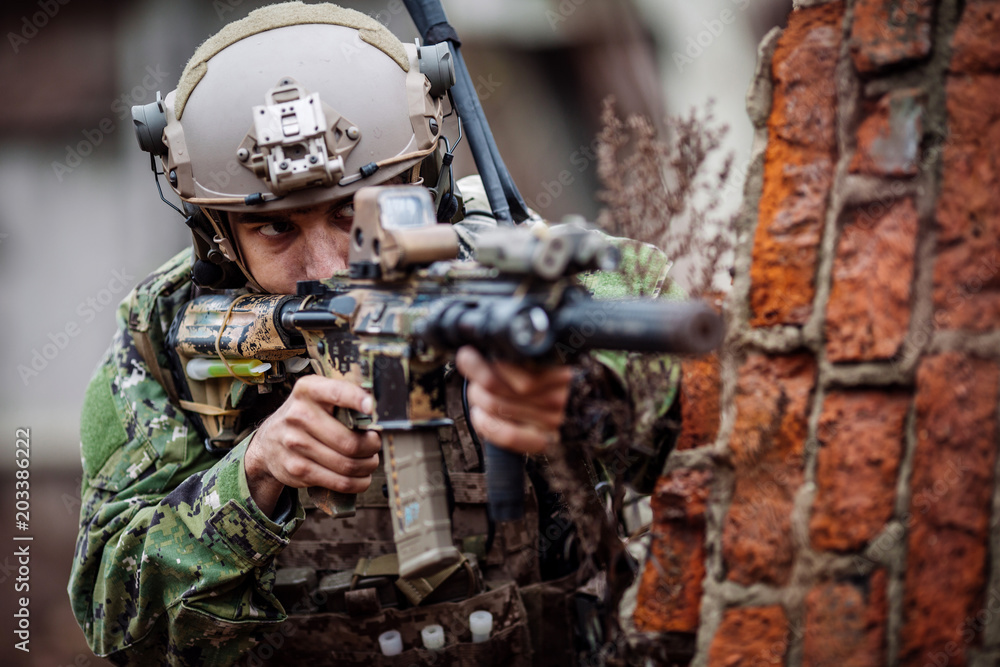 Fototapeta premium soldiers or private military contractors aiming with rifle. war, army, weapon, technology and people concept.