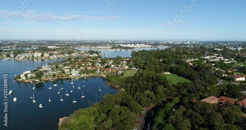 Developed shores of Greater Sydney along Parramatta river near Gladesville bridge towards distant Parramatta CBD.
 photo