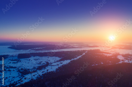 Sunset over countryside in winter. Aerial view 