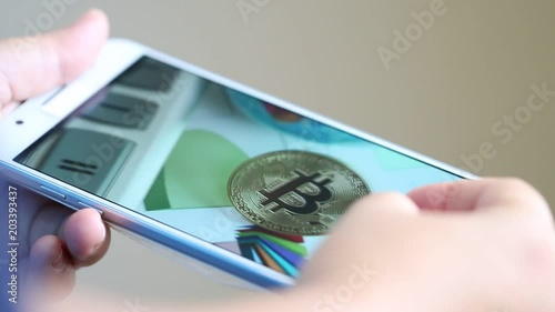 Businessman checking photo Gold Bitcoins circuit in smartphone for using presentation. Finance and business risk concept photo