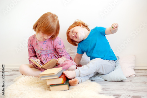 The elder sister reads to the brother of the book