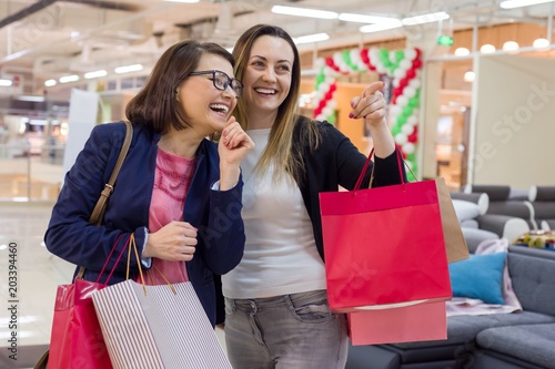 Two female enjoying shopping at mall