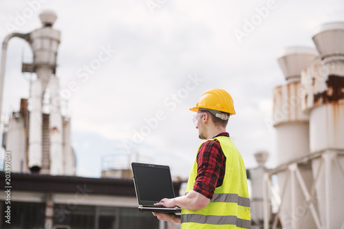 Construction worker or engineer using laptop © Novak