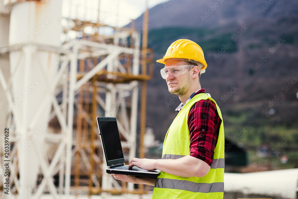 Construction worker or engineer using laptop Construction worker or engineer using laptop
