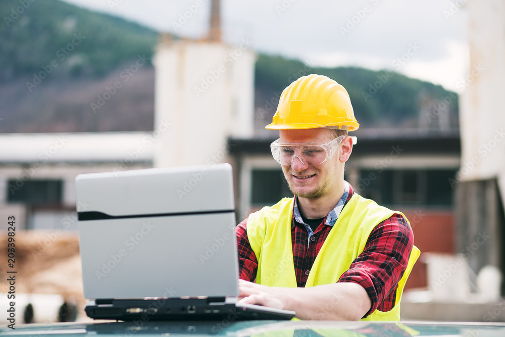 Construction worker or engineer using laptop Construction worker or engineer using laptop