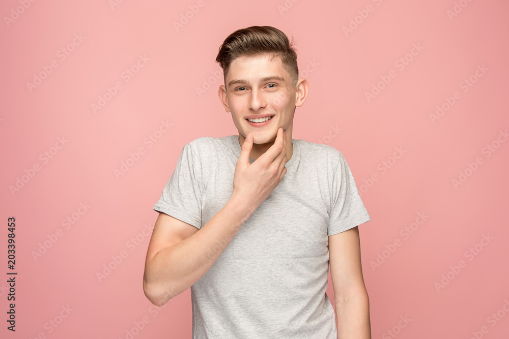 The happy business man standing and smiling against pink background. The happy business man standing and smiling against pink background.