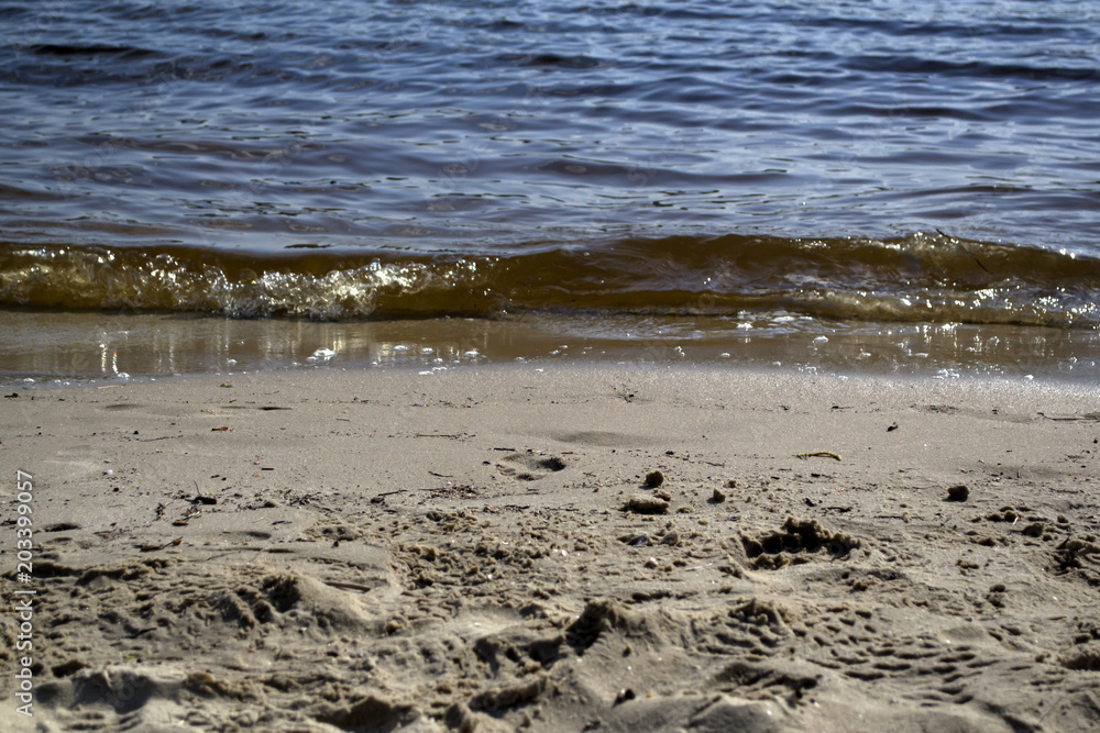 Wet sand and soft waves on a beach. Wet sand and soft waves on a beach.