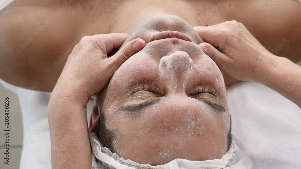 Man in beauty clinic. Male client gets facial cosmetology procedure in beauty salon. Face lymphatic massage Man in beauty clinic. Male client gets facial cosmetology procedure in beauty salon. Face lymphatic massage