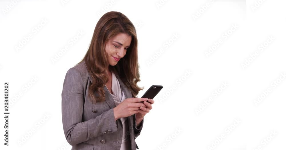 Portrait of white brunette reading something on cellphone on white background Portrait of white brunette reading something on cellphone on white background
