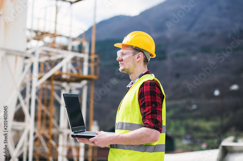 Construction worker or engineer using laptop